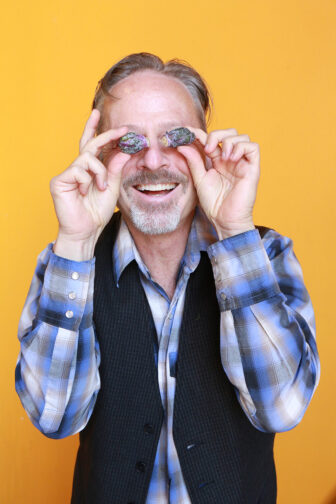 Rick holding blueberries up to his eyes