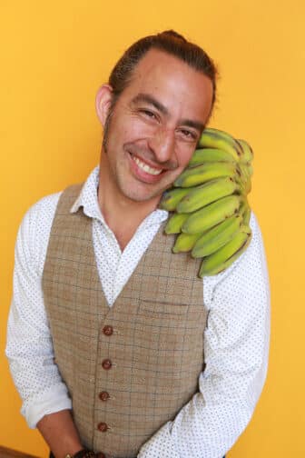 Amir holding bananas on his shoulder