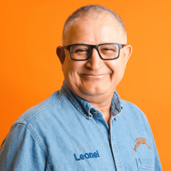 Leo smiling in Food Forward shirt with name Leonel on it