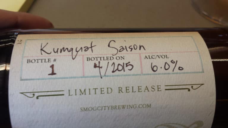 A label of Kumquat Saison, that denotes the bottling date and alcohol percentage.