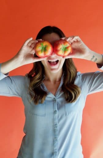 Sierra holding fake tomatoes up to her eyes