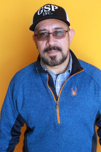 Lupe in black hat and blue jacket