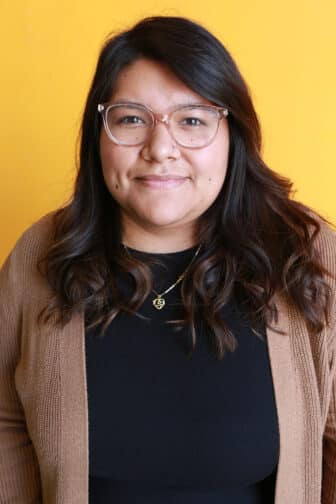 Angie in front of orange background