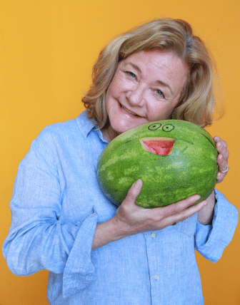 Ellen smiling and holding a watermelon