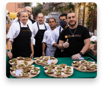 Chefs at the Spring Melt smiling with plates of food