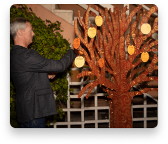 Guest at Spring Melt adding to the giving tree